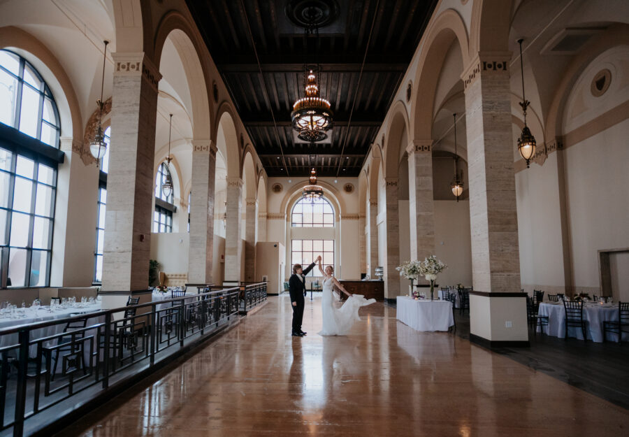 Bride twirling during a romantic dance in the grand historic ballroom at The Reserve.