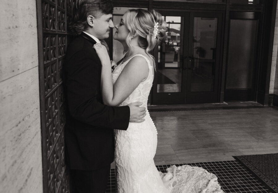 Bride and groom sharing a quiet moment near the entrance of The Reserve a Grand Venue.
